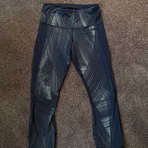 LULU LEMON athletic leggings with safari print, side pockets, and hem detailing